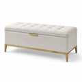 Panca contenitore in tessuto beige con gambe dorate